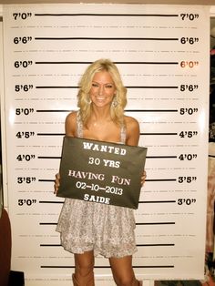 a woman holding up a sign that says wanted 50 years having fun