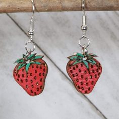 Welcome, my dear strawberry-loving friend, to the whimsical world of our Strawberry Wooden Dangle Earrings! These little gems are the perfect way to add a pop of fruity goodness to your everyday outfit, or to show off your love of all things garden, strawberry shortcake, and festival fun. Crafted from lightweight, hypoallergenic materials, these earrings are sure to be a comfortable addition to your jewelry collection. And with their nickel-free construction, you won't have to worry about any pesky allergic reactions spoiling your fun. So whether you're strolling through the local farmer's market or dancing the night away at your favorite festival, these Strawberry Wooden Dangle Earrings are sure to turn heads and spark conversations. And who knows? Maybe they'll even inspire a few fellow Garden Strawberry, Diy Earrings Polymer Clay, Plant Jewelry, Light Earrings, The Woodlands, Everyday Outfit, Etsy Earrings Dangle, Strawberry Shortcake, Diy Earrings