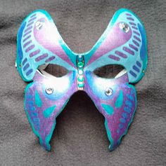 Butterfly mask - Hand-painted  Butterfly Mask. Full face party mask. The masquerade mask is Hand-painted with metallic gel pens and adorned with sparkling jewels. The mask is lined and attaches with an elastic strap. Great for Masquerade and Mardi Gras. Fits most. designAnn Original Mask See more at http://www.designAnn.etsy.com Butterfly Mask Design, Mask Butterfly, Aesthetic Mask, Mask Full Face, Lace Parasol, Butterfly Mask, Painted Butterfly, Mask Shapes, Theatre Masks