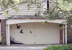 a garage with two birds painted on it