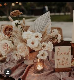 a table with flowers and candles on it