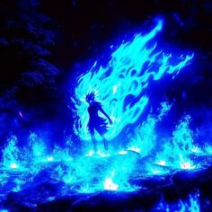 a person standing in front of a blue fire