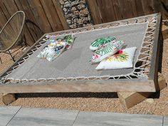 an outdoor table with pillows on it