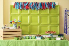 a green wall decorated with cupcakes and candy