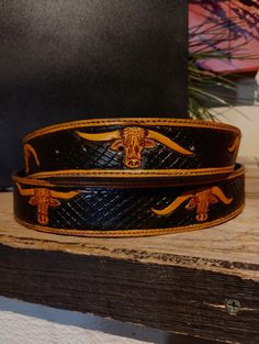 Tooled leather belt with nine unique longhorns. The background is dyed black with a cross hatch design.  Measures 40 inches from the bend to the middle hole. 1.5 inches wide. This item is hand tooled, dyed, and sewn. Features snaps to easily change out your buckle. If this is not your size send me a message and I can make one in your size. Western Style Black Belt For Western-themed Events, Western Style Black Belt For Ranch, Black Concho Belt Buckles For Ranch, Black Concho Belt Buckles, Black Hand Tooled Western Belt Buckles, Black Hand Tooled Leather Belt Buckles, Black Leather Hand Tooled Belt Buckles, Buffalo Head, Belt Western