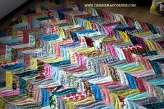 a colorful quilt is laying on the floor