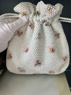 This vintage handbag is in near perfect condition. It is has a drawstring top.  The exterior has tiny white beads and small embroidered floral bouquets with clear beads. All beads are in place.  This unsigned Lumure handbags were popular in the 1960s, when beaded purses were a must for any fashionista. The inside is in great condition, no stains or tears.  Measurement: 9.5"x 9 x  Item will be gift wrapped and shipped to US destinations free of charge. Bead Handbag, Mid Century Floral, Glass Feather, Floral Purse, Clear Beads, Vintage Handbag, Drawstring Top, Top Handle Bags, Beaded Handbag