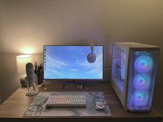 a desktop computer sitting on top of a wooden desk next to a keyboard and mouse