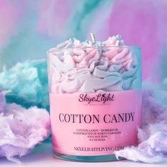 a pink and white candle with cotton candy in it