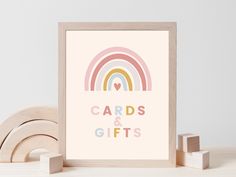 an art print with the words cards and gifts in pastel colors next to wooden blocks