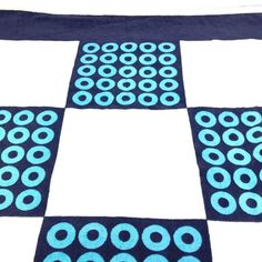 a blue and white rug with circles on it