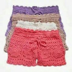 four pairs of crocheted shorts with bows on the front and bottom, all in different colors