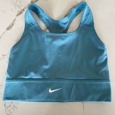 Teal Nike Sports Bra! Size Medium! No Pads Never Worn! Perfect Condition!! Medium Support Sports Bra In Blue, Blue Racerback Sports Bra With Medium Bust Support, Blue Sports Bra With Medium Bust Support, Blue Athleisure Bra For Workout, Fitted Blue Crop Top, Blue Sports Crop Top Bra Friendly, Blue Sports Bra With Medium Support For Workout, Blue Top For Training With Light Support, Sporty Blue Tops With Medium Bust Support