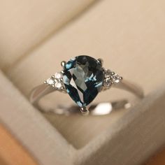 This ring features a 7*9 mm pear cut Genuine London blue topaz . Customization is available. It is made by hand, and it will take about 7 days to finish the ring after your payment is completed. Main stone: 7*9 mm pear cut Genuine London blue topaz Main stone weight: 2.10 ct Metal type: sterling silver /14k gold Accent stone: cz Customization is available, just fee free to contact me, it is free to engrave inside the ring, it is free, you can leave a ntoe with your order, but it will be great no Pear-shaped Topaz Promise Ring, Fine Jewelry Pear-shaped Topaz Ring, Fine Jewelry Pear-shaped Topaz Ring For Anniversary, Pear-shaped Topaz Ring For Anniversary, Fine Jewelry, Teardrop Topaz Ring With Accent Stones For Anniversary, Pear-shaped Topaz Promise Ring With Prong Setting, Pear-shaped Topaz Promise Ring With Accent Stones, Anniversary Blue Topaz Teardrop Ring, Pear-shaped Topaz Ring For Anniversary