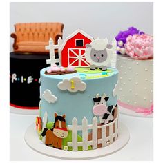 three cakes decorated with farm animals, horses and barn designs on top of each other