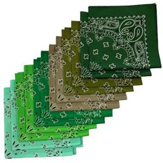 six green napkins with paisley designs on them