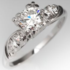 Circa 1950s ring is centered with one (1) round brilliant cut diamond set into a four-prong fishtail style head. The shoulders are each accented with two (2), prong set, round single cut diamonds. The ring measures 6.5mm at the top, rises 7.0mm above the finger, tapering to 1.3mm wide and 1.0mm thick at the base of the shank. We offer complimentary ring sizing to fit. 1950s Ring, Vintage Diamond Engagement Ring, Antique Diamond Rings, Diamond Engagement Rings Vintage, Antique Engagement, Antique Engagement Rings, Emerald Jewelry, Diamond Set, Vintage Diamond