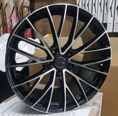 a black and silver wheel on top of a cardboard box