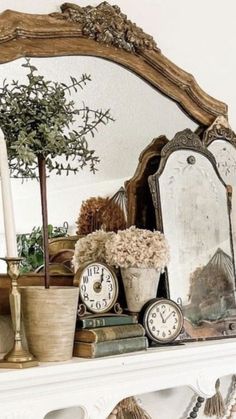 there is a mirror, clock and other items on the mantle