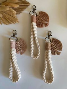 three different key chains with tassels attached to them, hanging on a wall