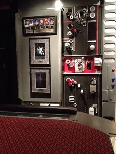 a room with many different types of electronics on the wall and carpeted flooring