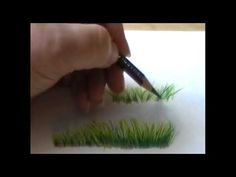 someone is drawing grass with a marker