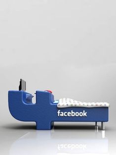 a blue facebook bed with the word facebook on it's headboard and foot board