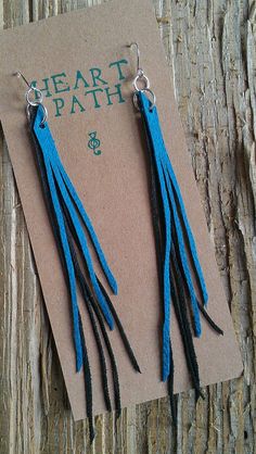 two pairs of blue and black leather earrings on a piece of paper with the words heart path written in green