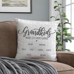 a couch with a pillow that says grandkids make little more grand on it