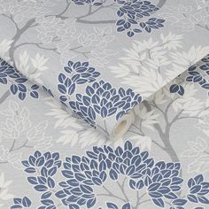 a blue and white wallpaper with flowers on the back of it's cover