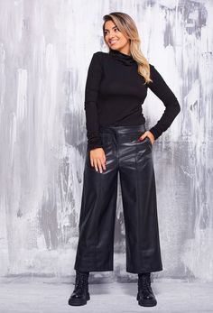 "These faux leather pants are a true symbol of elegance and retro style, inspired by the unique era of the 90s. Its calf-length length lends a casual yet impactful charm. The front zip fastening and hidden button ensure a perfect fit and accentuate the contours of the body. The front pockets add practicality, while the masterfully recreated back pockets are an elegant imitation with subtle detailing on the fillets. The slightly flared legs with the front decorative seam give the trousers character and uniqueness. Made of supple and soft synthetic leather, it provides all-day comfort and freedom of movement. The possibility to choose from several colors makes it a universal choice for any fashion combination. This pant is a true symbol of aesthetics and style that brings to life the spirit Caprese Pants Outfits, Capri Wide Leg Pants Outfit, Cropped Faux Leather Pants Outfit, Elegant Wide-leg Leather Pants For Night Out, Faux Leather Wide Leg Pants For Fall, Fall Wide Leg Faux Leather Pants, Faux Leather Full-length Pants For Fall, Fall Faux Leather Full-length Pants, Fall Full-length Faux Leather Pants