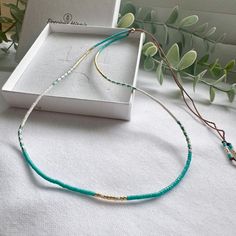 A beautifully dainty adjustable silk necklace with tiny turquoise and gold seed beads. Wear it solo or layer with others to create your unique bohemian look. It's the perfect addition to your summer accessories and a popular beach necklace.  We recommend layering with our Tiny Turquoise seed bead necklace: https://precioushippieuk.etsy.com/listing/1263330156 Hand-threaded on quality silk cord (beige colour) and secured with a 14k Gold filled slider bead. At its shortest this necklace is 16inches, it is adjustable up to 26 inches and will fit over your head. Your hippie style necklace will come in gift ready packaging. Explore more turquoise jewellery, mix and match from the Precious Hippie collection to create your unique stacks  https://precioushippieuk.etsy.com?section_id=49340267 Turquoise Seed Bead Necklace, Turquoise Jewellery, Silk Necklace, Beach Necklace, Turquoise And Gold, Beach Necklaces, Beige Colour, Necklace Turquoise, Silk Cord