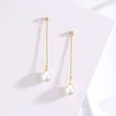 Elevate your ensemble with the exquisite elegance of our Natural Freshwater Pearl Long Earrings. Crafted with AAAA-grade natural freshwater pearls, these earrings boast a luxurious allure. Set in s925 silver with stunning 18K gold vermeil details, they exude sophistication and charm. Perfect for special occasions, these earrings offer a timeless and opulent look that enhances any outfit. The top stud features a sparkling cubic zirconia, while a long bead drop chain culminates in a lustrous 8-9mm Elegant Gold Plated Linear Earrings For Anniversary, Elegant Gold Plated Linear Earrings, Exquisite Pearl Drop Earrings, Elegant Pearl Earrings With Pearl Chain, Elegant Drop Linear Earrings, Elegant Gold Plated Linear Earrings For Gift, Luxury Drop Pearl Earrings With Pendant, Luxury Pearl Drop Earrings With Pendant, Graceful Pearl Earrings With Pearl Pendant