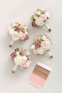 three bridal bouquets with pink, white and peach flowers next to each other