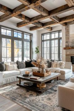 a living room filled with furniture and large windows