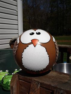 an owl painted on top of a wooden box