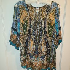 Never Worn And In Fabulous Condition Bila Blouse With Peek-A-Boo Shoulders. Peasant/Boho Style With 3/4 Flounce Leave. Embroidered Trim On Hem And Sleeves. Size S/Measurements: Pit - Pit =20" X 26" Long. Perfect Paired With Shorts, Jeans, Skirt. 100% Rayon. Flowy Patterned Blouse With Boho Print, Flowy Boho Print Patterned Blouse, Blue Paisley Print Summer Blouse, Blue Bohemian Tops With Paisley Print, Bohemian Blue Tops With Paisley Print, Bohemian Green Tops With Paisley Print, Blue Paisley Print Bohemian Tops, Bohemian Short Sleeve Blouse With Paisley Print, Fall Vacation Paisley Print Blouse