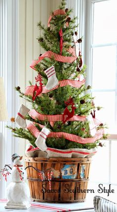 a small christmas tree in a wooden basket