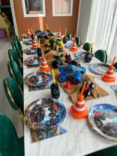 a table set up with cars and traffic cones on it for a birthday or baby shower