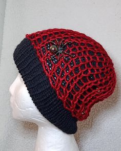 a red and black hat on top of a white mannequin head