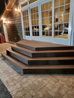 a set of steps leading up to a patio with sliding glass doors on each side