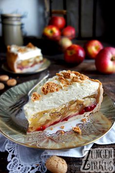 a piece of pie sitting on top of a plate next to nuts and an apple