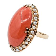 Vibrant 18k Coral & Seed Pearl Cocktail Ring Introducing this exquisite vintage coral cocktail ring. Expertly crafted in 18k yellow gold, it prominently features a radiant 27x16mm oval Coral cabochon in a vibrant reddish-orange color. The stunning coral is accompanied by a halo of lustrous seed pearls of twenty-nine 2mm seed pearls, adding a touch of elegance and finesse. This unique ring is currently a size 4.5, but can be resized upon request for a small fee for a perfect fit. Tipping the scales at 13.05 grams, this eye-catching vintage cocktail ring promises to be a standout addition to any jewelry collection, bringing with it a hint of nostalgia and timeless beauty. This beautiful ring is ready to wear, collect or gift to someone special. 00116688 Pearl Cocktail Ring, Cocktail Vintage, Vintage Cocktail Ring, Reddish Orange, Vintage Cocktail, Unique Ring, Seed Pearl, Halo Rings, Ring Vintage