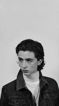 black and white photograph of a young man wearing a denim jacket