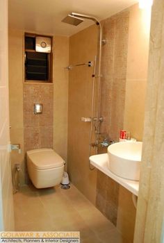 a bathroom with a toilet, sink and shower in it's stall door area