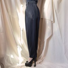 From YSL’s Rive Gauche line, these trousers are the perfect staple to add to your closet. The double button waistband and double pleats in the front allow for a comfortable yet incredibly flattering fit and the loose, almost wide leg cut of the trousers allow for easy styling with sneakers and heels alike. Beautiful and well-made, these are a great example of why people shop vintage. Size: FR 36, US 2/4 Composition: 100% wool Condition: Perfect, no visible stains, snags, holesMeasurements: Waist High Waist Pleated Formal Pants, Tailored Pleated Evening Bottoms, Elegant Tapered Leg Dress Pants With Button Closure, Elegant Semi-formal Bottoms With Button Closure, Spring High-waisted Pants With Pressed Crease, High-waist Bottoms With Pressed Crease For Spring, High Waist Bottoms With Pressed Crease For Spring, Tailored Evening Bottoms With Belt Loops, High Waist Pants With Pressed Crease For Spring