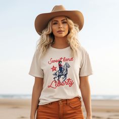 Sweet Land of Liberty Vintage Graphic Tee Celebrate your patriotic spirit with my vintage-inspired "Sweet Land of Liberty" graphic tee from Boots and Roots Apparel Co. 🇺🇸 This shirt features a beautifully distressed design that pays homage to classic Americana, perfect for those who love a touch of nostalgia in their wardrobe. Crafted from soft, high-quality fabric, this tee offers both comfort and style, making it a go-to choice for all your summer festivities, from backyard barbecues to fire Vintage 4th Of July T-shirt With Letter Print, Americana Crew Neck T-shirt Made In Usa, 4th Of July Americana Graphic T-shirt, Vintage American Flag Print Tops For 4th Of July, Vintage Cotton T-shirt With American Flag Print, Vintage American Flag Print Cotton T-shirt, Summer Americana Pre-shrunk T-shirt, Americana Style Graphic Print Short Sleeve T-shirt, Americana Style Pre-shrunk Summer T-shirt