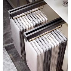 a bunch of folders sitting on top of each other in front of a desk