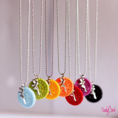 four necklaces with different colors and designs on them