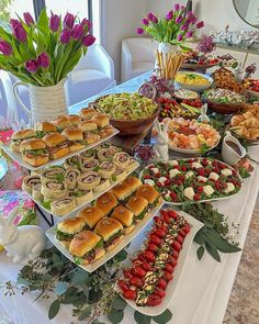 a table filled with lots of food and flowers